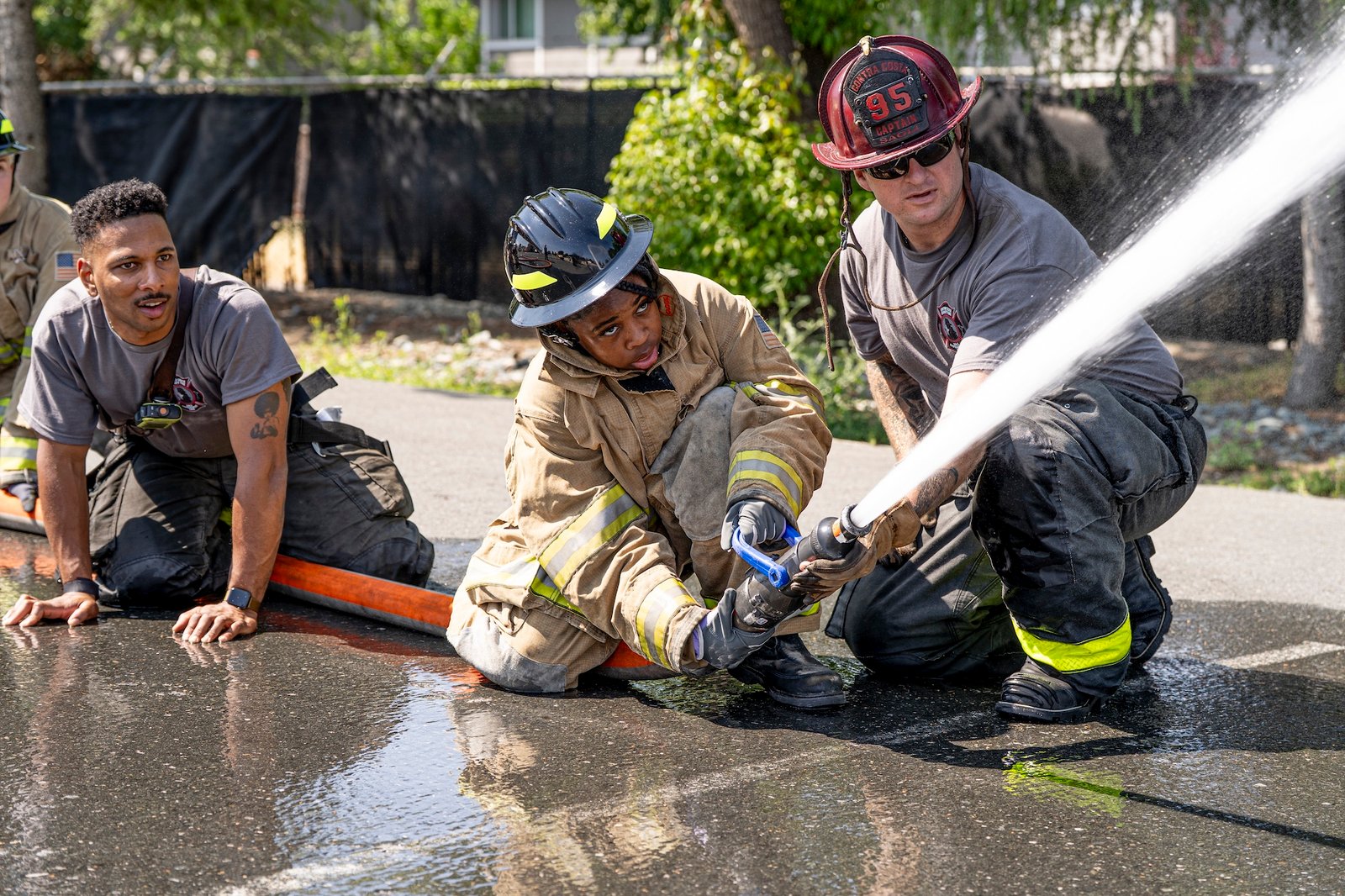 A Camper spraying a fire hose at GEC