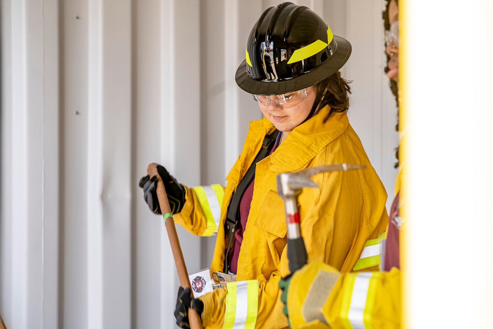 a camper holding a tool and looking down